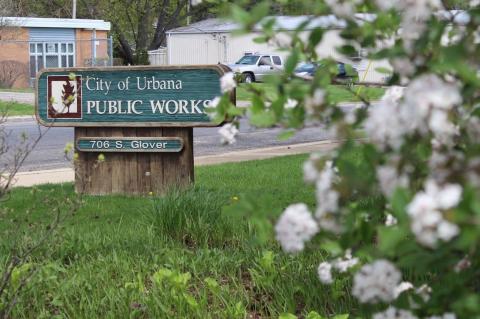 Public Works Department sign with blooming white flowers in springtime